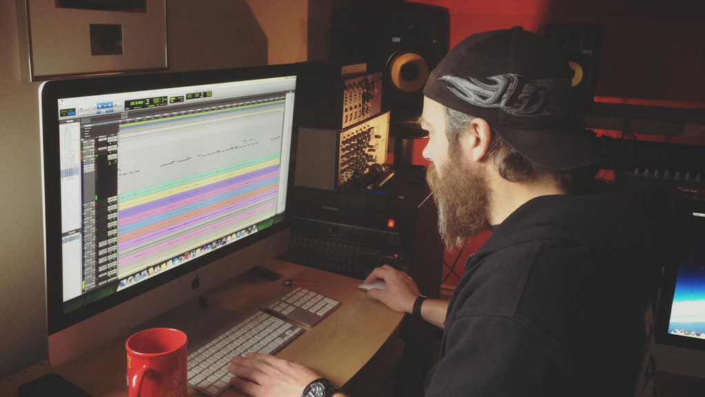 a screenshot from within a recording studio with a sound engineer